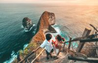 Couple Travel view of landscape with Kelingking beach, Nusa Penida island Bali ,Indonesia